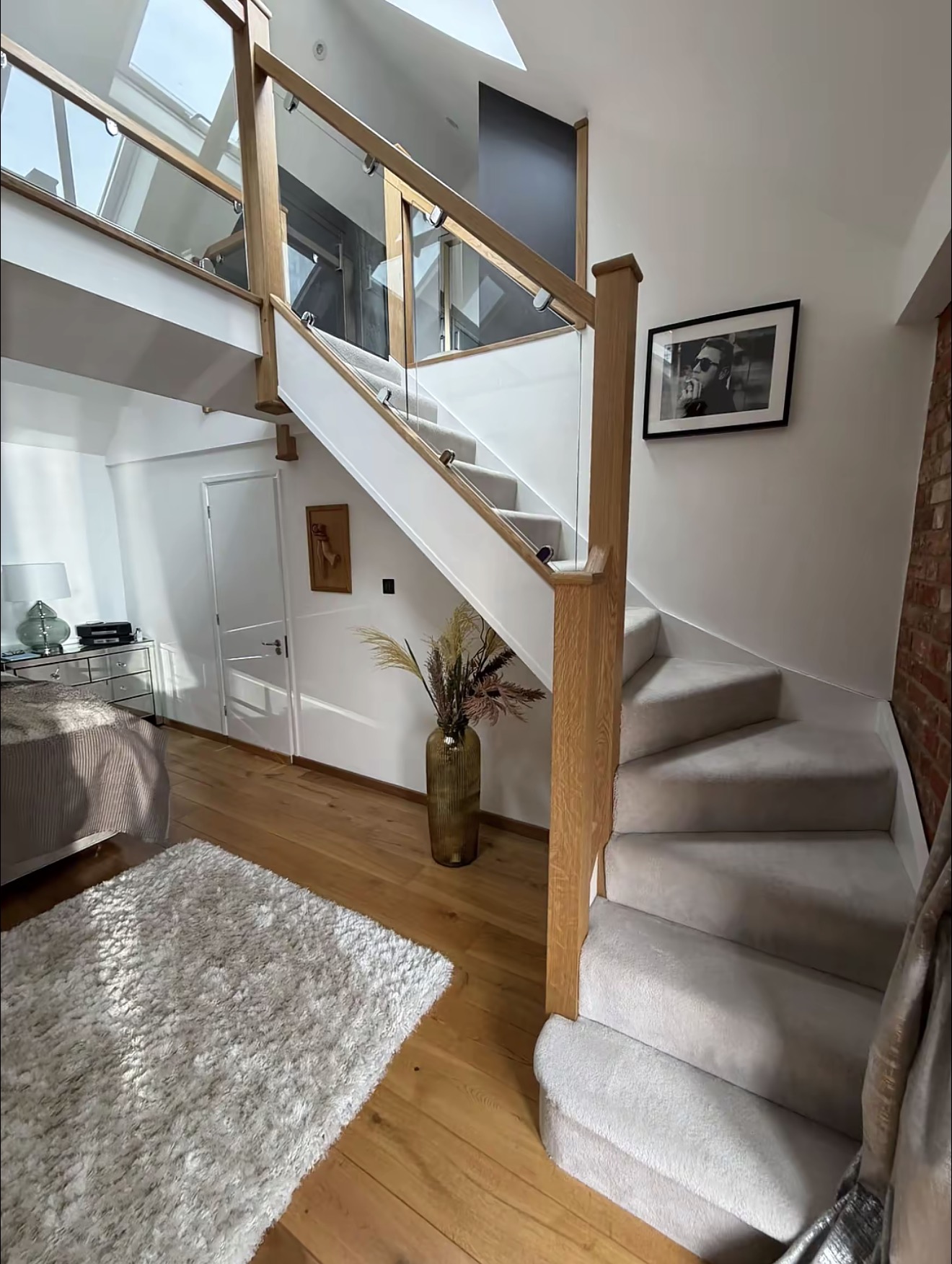 Finished oak staircase with glass balustrade and timber rails