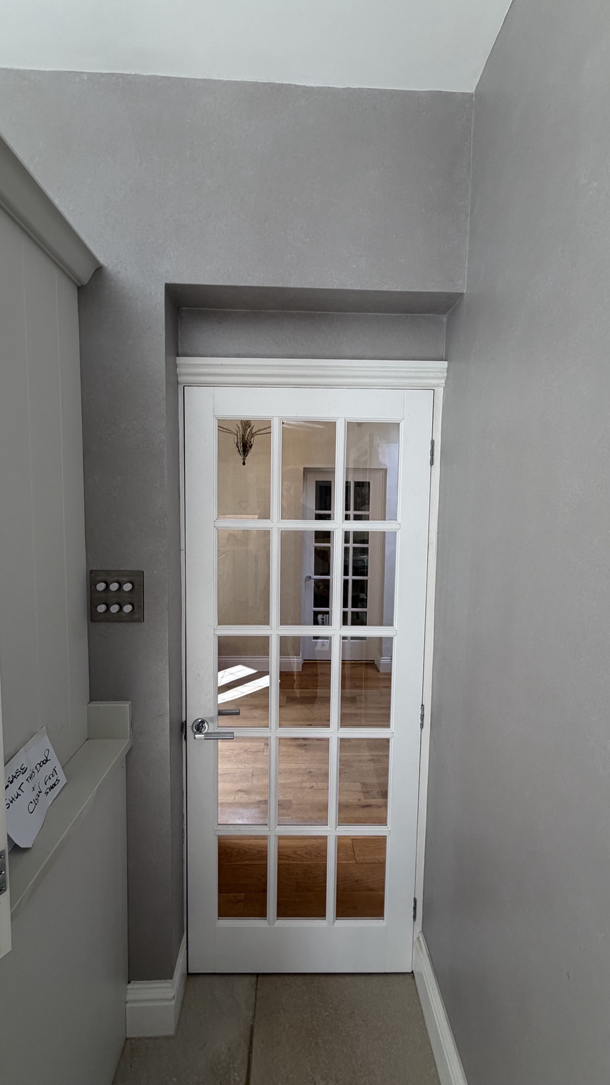 White glazed internal door fitted into a hallway
